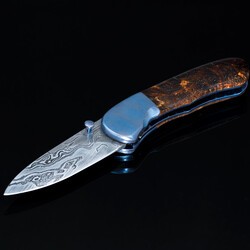 Textured titanium spalted maple and Damascus folder left view