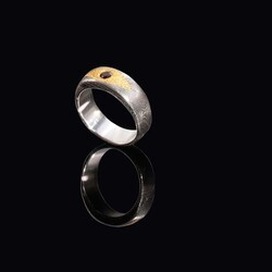 Damascus ring with genuine ruby set in 24 carat gold side view