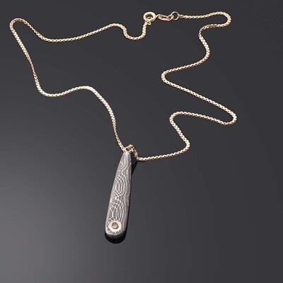 Chocolate diamond set in gold and stainless damascus pendant