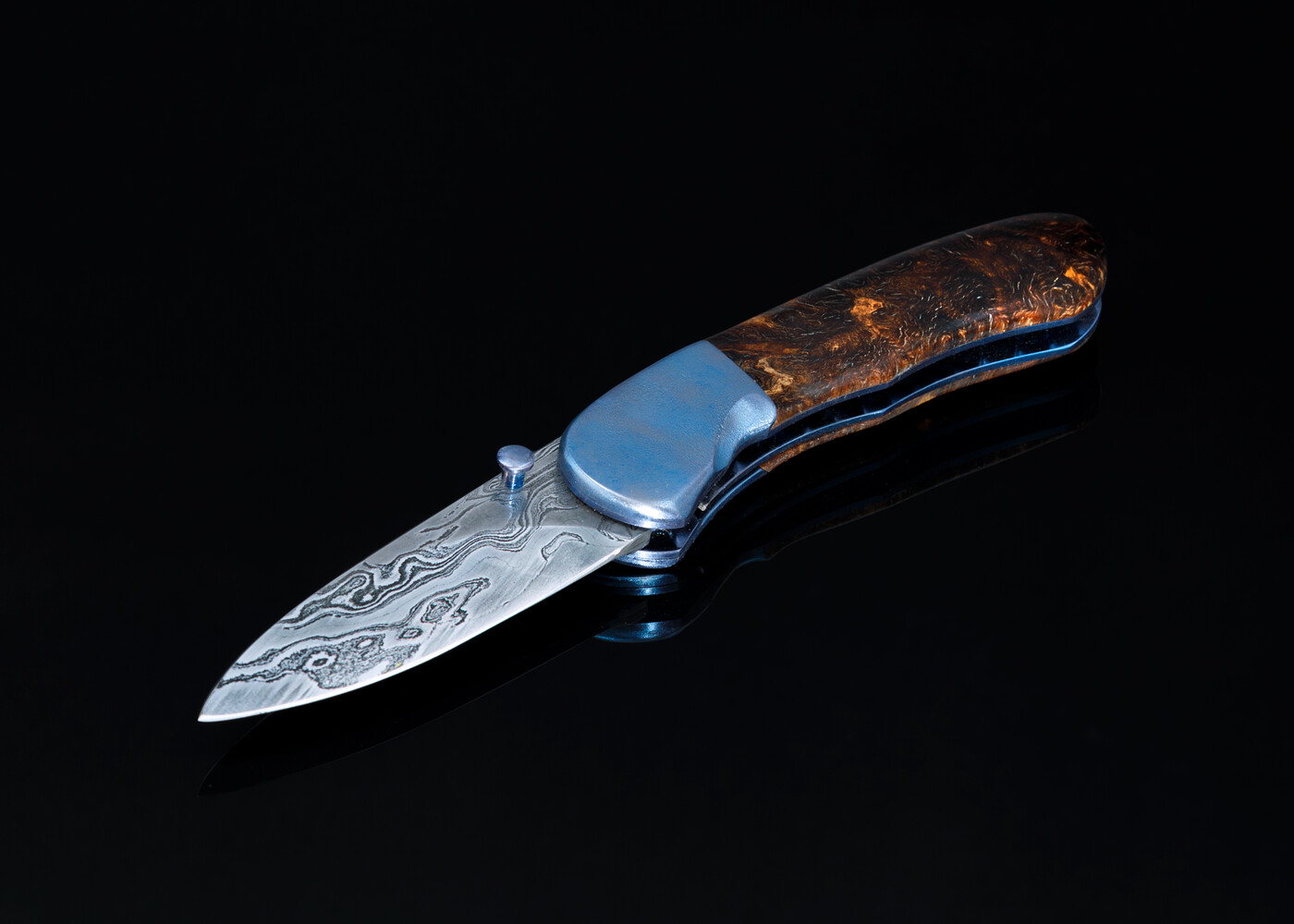 Textured titanium spalted maple and Damascus folder left view