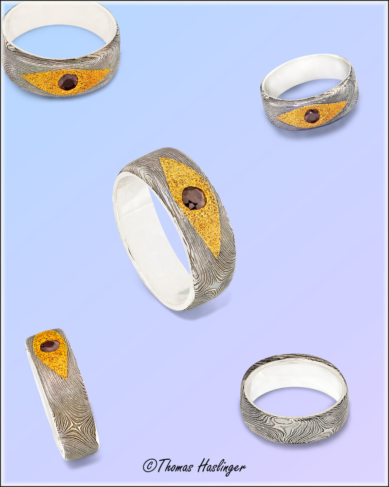Damascus ring with genuine ruby set in 24 carat gold