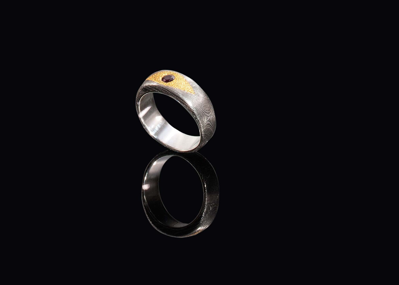 Damascus ring with genuine ruby set in 24 carat gold side view