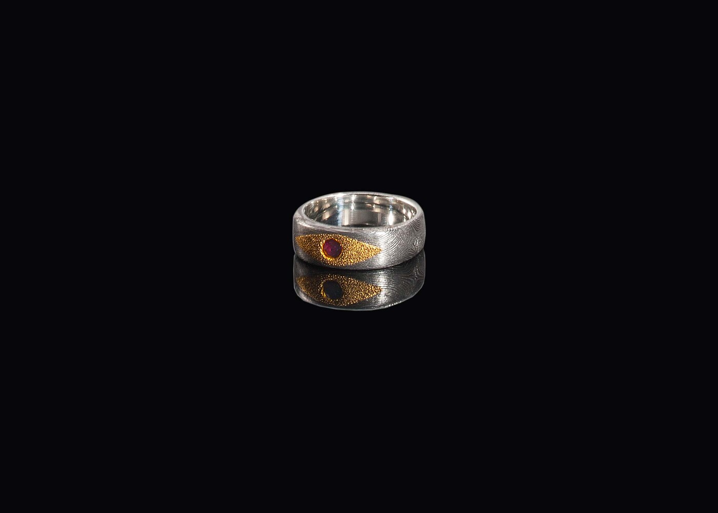 Damascus ring with genuine ruby set in 24 carat gold view